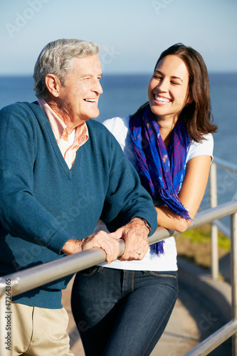 Photo: Senior Man With Adult Daughter Looking Over Railing At Sea Senior Man With Adult Daughter Looking Over Railing At Sea