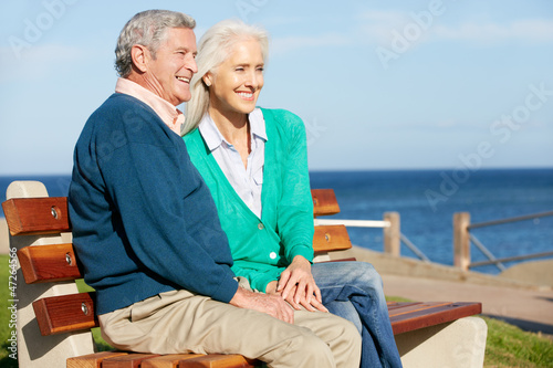 Photo: Senior Couple Sitting On Bench By Sea Together Senior Couple Sitting On Bench By Sea Together