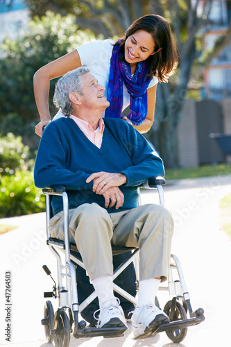 Photo: Adult Daughter Pushing Senior Father In Wheelchair Adult Daughter Pushing Senior Father In Wheelchair