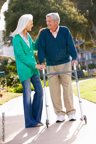 Photo: Senior Woman Helping Husband With Walking Frame Senior Woman Helping Husband With Walking Frame