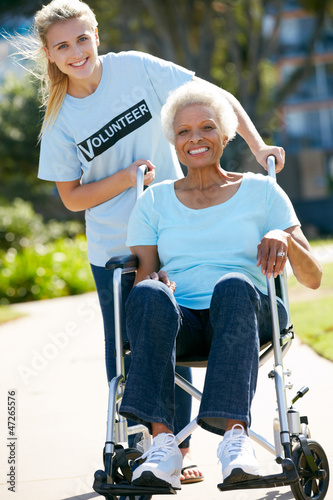Photo: Teenage Volunteer Pushing Senior Woman In Wheelchair Teenage Volunteer Pushing Senior Woman In Wheelchair