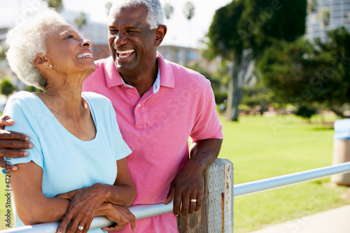 Photo: Senior Couple Walking In Park Together Senior Couple Walking In Park Together
