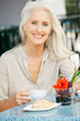 Photo: Senior Woman Enjoying Snack At Outdoor Café Senior Woman Enjoying Snack At Outdoor Café