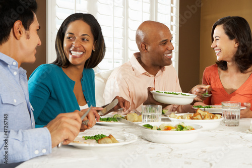 Photo: Group Of Friends Enjoying Meal At Home Group Of Friends Enjoying Meal At Home