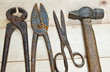 Hammer and nippers on wood background