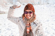 Photo: Happy young woman playing snowball fight Happy young woman playing snowball fight