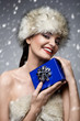 christmas picture of beautiful woman holding a blue present