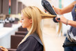 Getting her hair blow-dried by a professional
