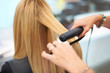 Straightening her hair for a sleek new look