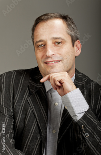 Photo: portrait of adult man isolated on dark background portrait of adult man isolated on dark background