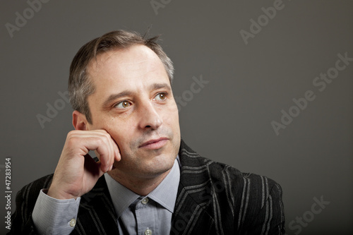 Photo: portrait of adult man isolated on dark background portrait of adult man isolated on dark background