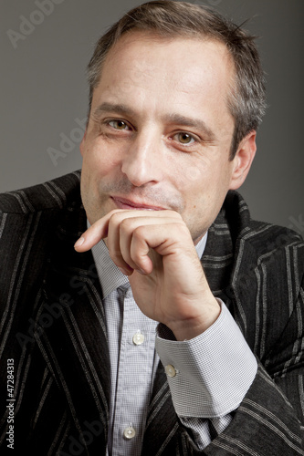 Photo: portrait of adult man isolated on dark background portrait of adult man isolated on dark background