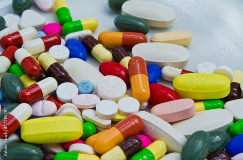 Photo: Pile of pills in medicine container Pile of pills in medicine container