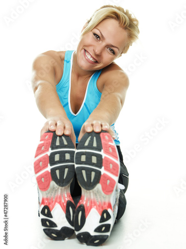 Photo: Beautiful atletic woman exercising on the floor Beautiful atletic woman exercising on the floor