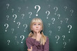 Photo: Girl at the Blackboard with Question Marks Girl at the Blackboard with Question Marks