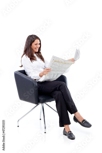Photo: Casual 20s women reading newspaper, amused Casual 20s women reading newspaper, amused