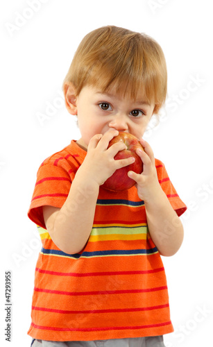 Photo: cute little boy eating apple, isolated on white cute little boy eating apple, isolated on white