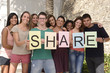 Photo: Diverse group holding sign with letters Share Diverse group holding sign with letters Share