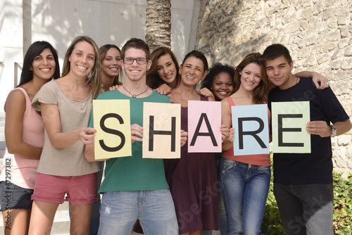Photo: Diverse group holding sign with letters Share Diverse group holding sign with letters Share