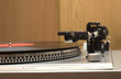 Stereo turntable and vinyl record with red label closeup