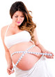 Pregnant woman measuring her belly