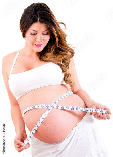 Photo: Pregnant woman measuring her belly Pregnant woman measuring her belly