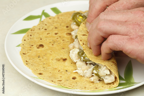 Photo: Hands Rolling a Vegetarian Wrap Hands Rolling a Vegetarian Wrap