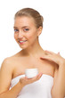 Young healthy girl applying body cream isolated