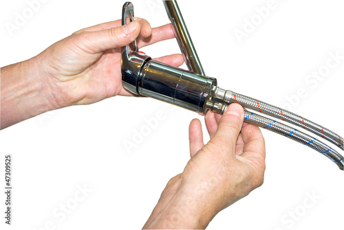 Photo: Handyman/plumber installing new tap isolated Handyman/plumber installing new tap isolated