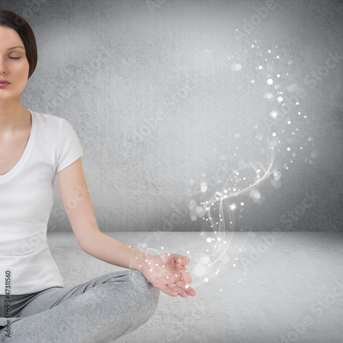 Photo: Pretty young woman meditating in empty room and graphic smoke, g Pretty young woman meditating in empty room and graphic smoke, g