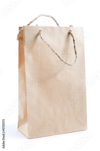 Photo: Blank brown paper bag isolated on white background Blank brown paper bag isolated on white background