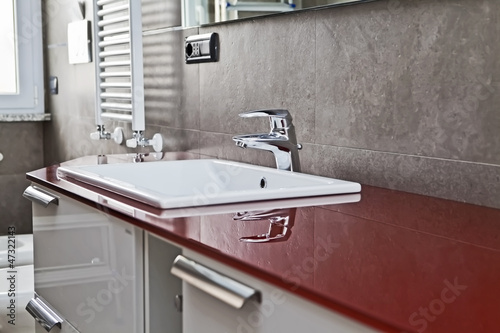 Photo: Red bathroom faucet reflection Red bathroom faucet reflection