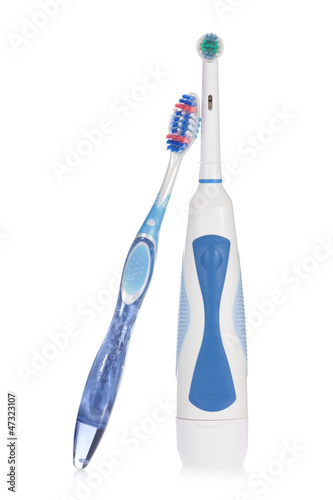 Photo: Electric and traditional toothbrushes isolated on white. Electric and traditional toothbrushes isolated on white.
