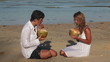 Video: Attractive couple drinking coconuts and sitting on beach Attractive couple drinking coconuts and sitting on beach