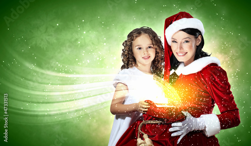 Photo: Little girl with christmas gifts and santa Little girl with christmas gifts and santa
