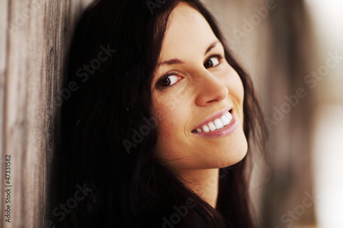 Photo: Young woman is smiling, outside in winter day. Young woman is smiling, outside in winter day.