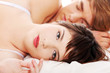 Beautiful young couple sleeping in bed.