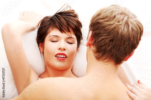 Photo: Young caucasian couple in bed Young caucasian couple in bed