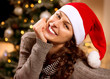 Christmas Woman in Santa Hat. Happy Smiling Girl