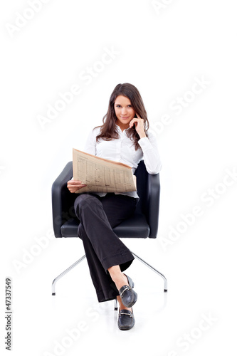 Photo: Casual 20s woman reading stock rates in newspaper 3 Casual 20s woman reading stock rates in newspaper 3
