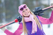Portrait of blondy young woman with ski in winter time