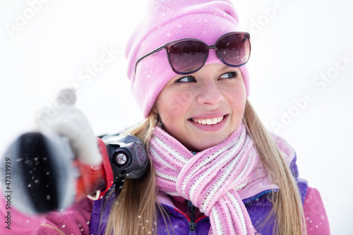 Photo: Portrait of blondy young woman with ski in winter time Portrait of blondy young woman with ski in winter time