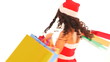 Woman in Santa hat holding shopping bag.