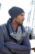 Trendy young man in hat and scarf