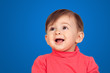 Surprised baby girl looking up