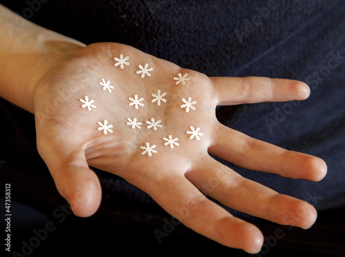Photo: Hand shows several handmade paper snowflakes Hand shows several handmade paper snowflakes