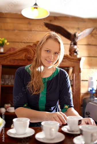 Photo: Woman makes coffee. Woman makes coffee.