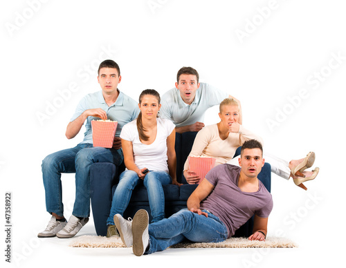 Photo: Young people sitting on a sofa on white background Young people sitting on a sofa on white background