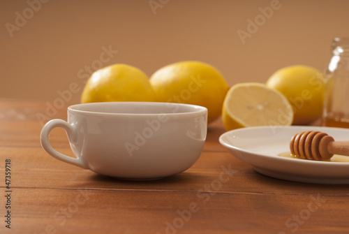Photo: Tea with honey and lemon on wooden table Tea with honey and lemon on wooden table