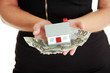 Photo: Woman holding euros bills and house model Woman holding euros bills and house model